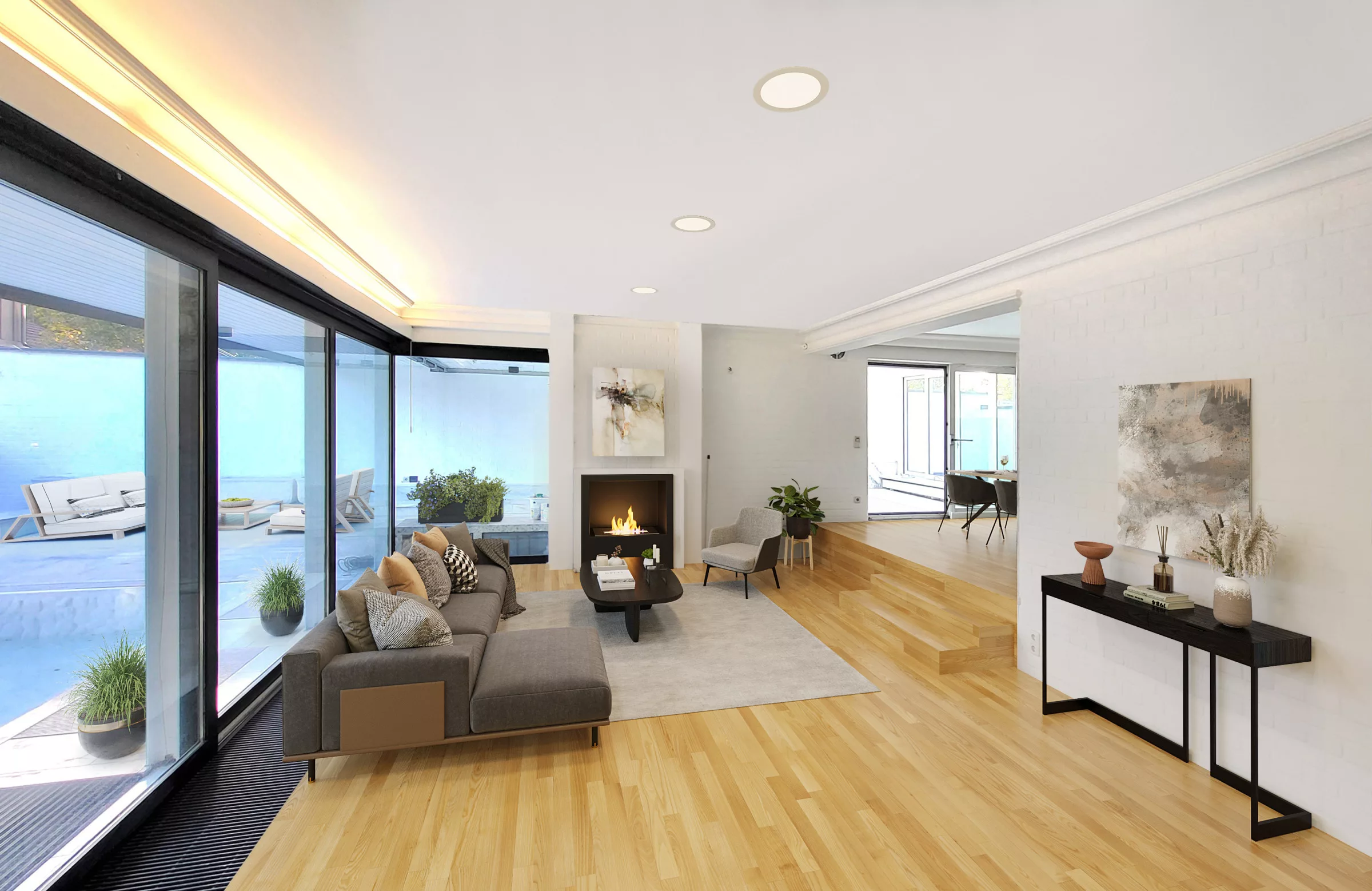 Home Staging Beispiel mit Feuer im Kamin in großem Wohnzimmer mit Holzboden und hoher Fensterfront