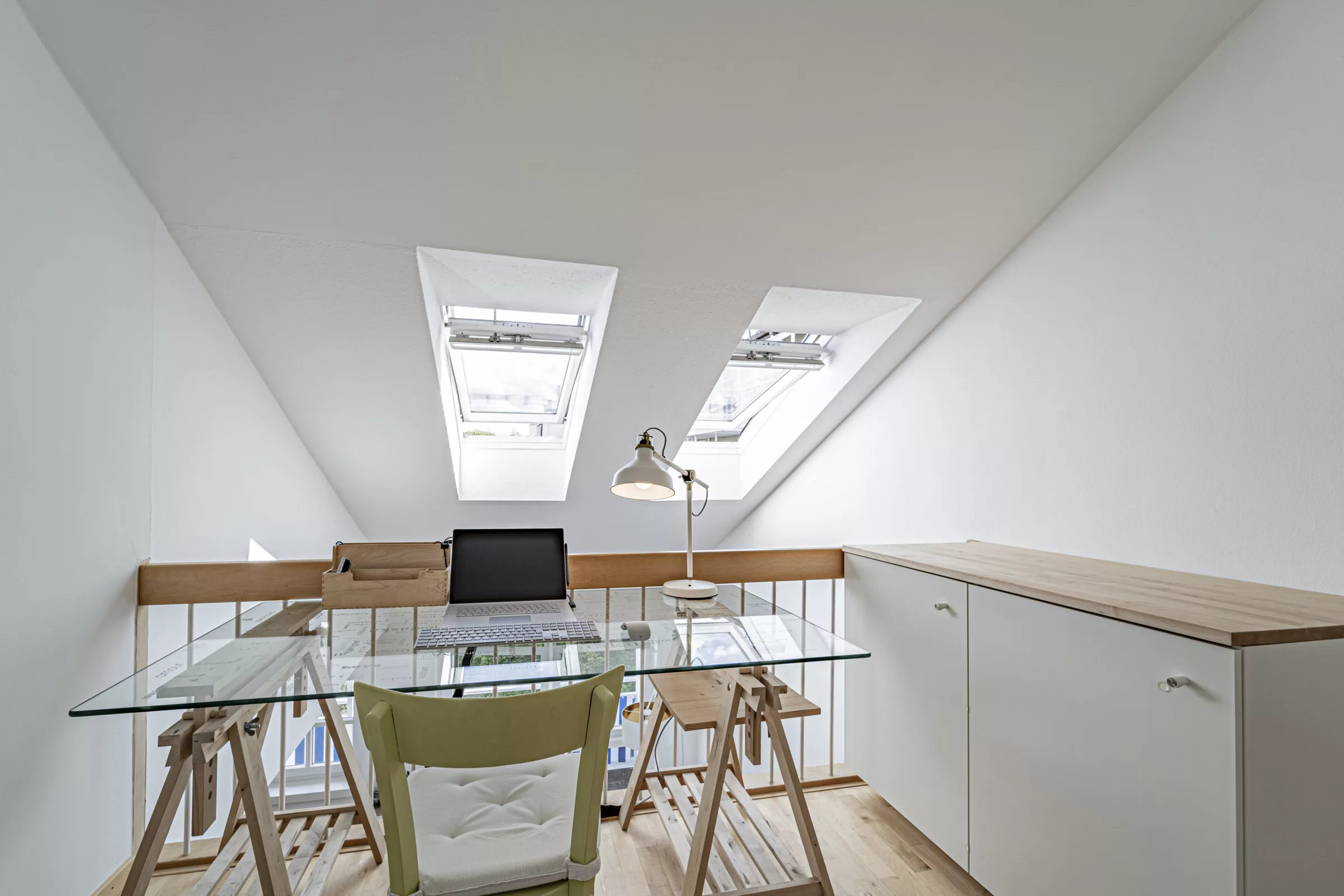 Helles Arbeitszimmer mit Schreibtisch und Fenstern